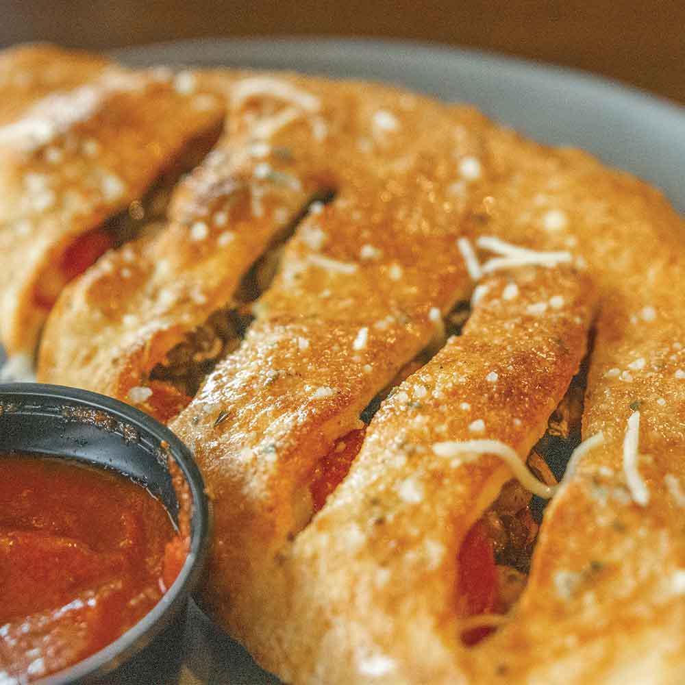 Deluxe Combination Calzone  · Pepperoni, Italian sausage, green peppers, red onions, & mushrooms.