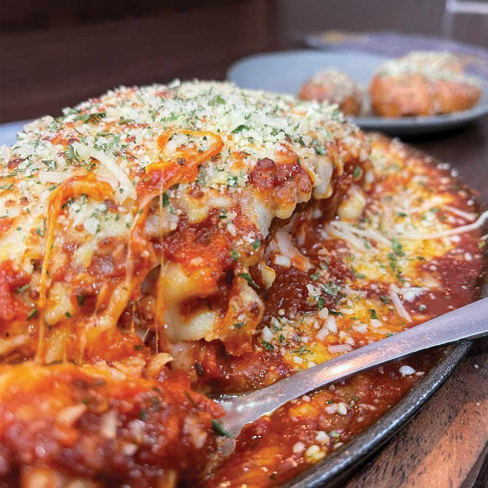 Rotolo's In-House Lasagna · Our classic lasagna amplified! handmade & baked in-house. six layers filled with fresh ricotta, mozzarella, marinara sauce, crumbled sausage, & our signature meatballs, topped with our authentic red gravy & smothered in mozzarella cheese.