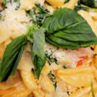 Pink Vodka Cavatelli Plate · Garlic, spinach, basil, cherry tomato, and rigatoni in a zesty vodka sauce topped with shave...