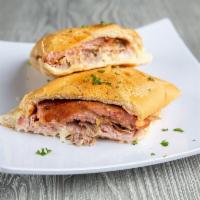 Croqueta Preparada Sandwich · Croquette sandwich on Cuban bread with croquettes, ham, pork and Swiss cheese.