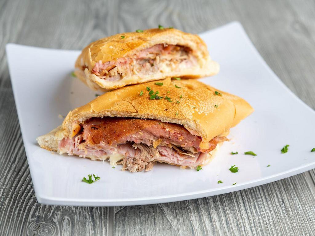 Croqueta Preparada Sandwich · Croquette sandwich on Cuban bread with croquettes, ham, pork and Swiss cheese.