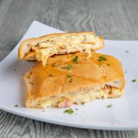 Pan con Tortilla · Scrambled egg sandwich on Cuban bread with ham and Swiss cheese.