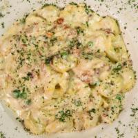 Carbonara Pasta · Onions, peas, bacon in a cream sauce and cheese tortellini recommended.