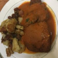 Paprika Schnitzel · Pork cutlets, breaded and fried with a creamy paprika gravy, served with German home fries a...