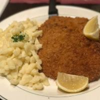 Hahnchen Schnitzel · Chicken cutlets, boneless, breaded and fried, served with spaetzel and a house salad.