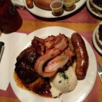 Bayrischer Bauernschmaus · Roast pork, a smoked chop, boiled double smoked bacon and a bratwurst served with mashed pot...