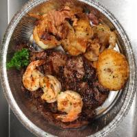 Ribeye Steak and Shrimp · Ribeye steak grilled to perfection topped with spicy marinated shrimp served with German hom...
