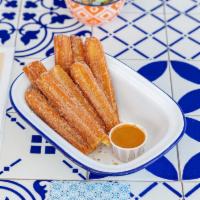 Churros · Dusted with sugar and cinnamon, served with a side of Dulce De Leche