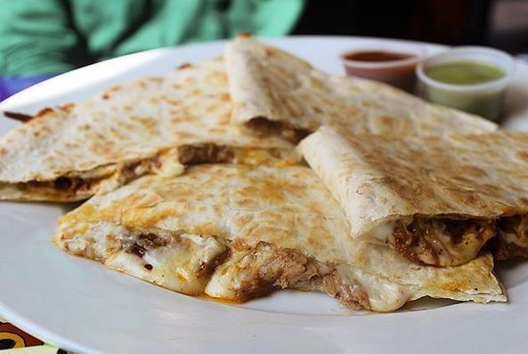 Carnitas Quesadilla · Grilled flour tortilla filled with mozzarella cheese and shredded pork. Served with chipotle and avocado salsas.