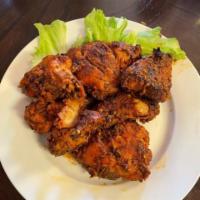 Spicy Peri peri Chicken  · well marinated and season cut up leg quarters, grilled and served with your choice of side  