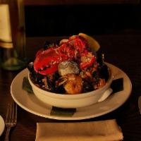 Mamajuana Paella for 3 People · Half lobster, shrimp, calamari, clams, mussels, chorizo, saffron rice, roasted peppers and s...