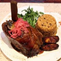 Puerquito · Serves 2. Caribbean style slow roasted pork, onion escabeche, sweet plantain, rice and peas.