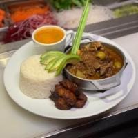 Chivo Guisado · Dominican style goat and black beans moro.