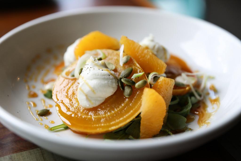 Golden Beet Salad · Arugula, oranges, pepitas, green onions, whipped honey goat cheese, and white balsamic reduction. Can be made vegan.