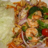 E1. Yum Seafood · Shrimp and squid mixed with chili paste, lemongrass, lime juice, tomato, mushroom and scalli...