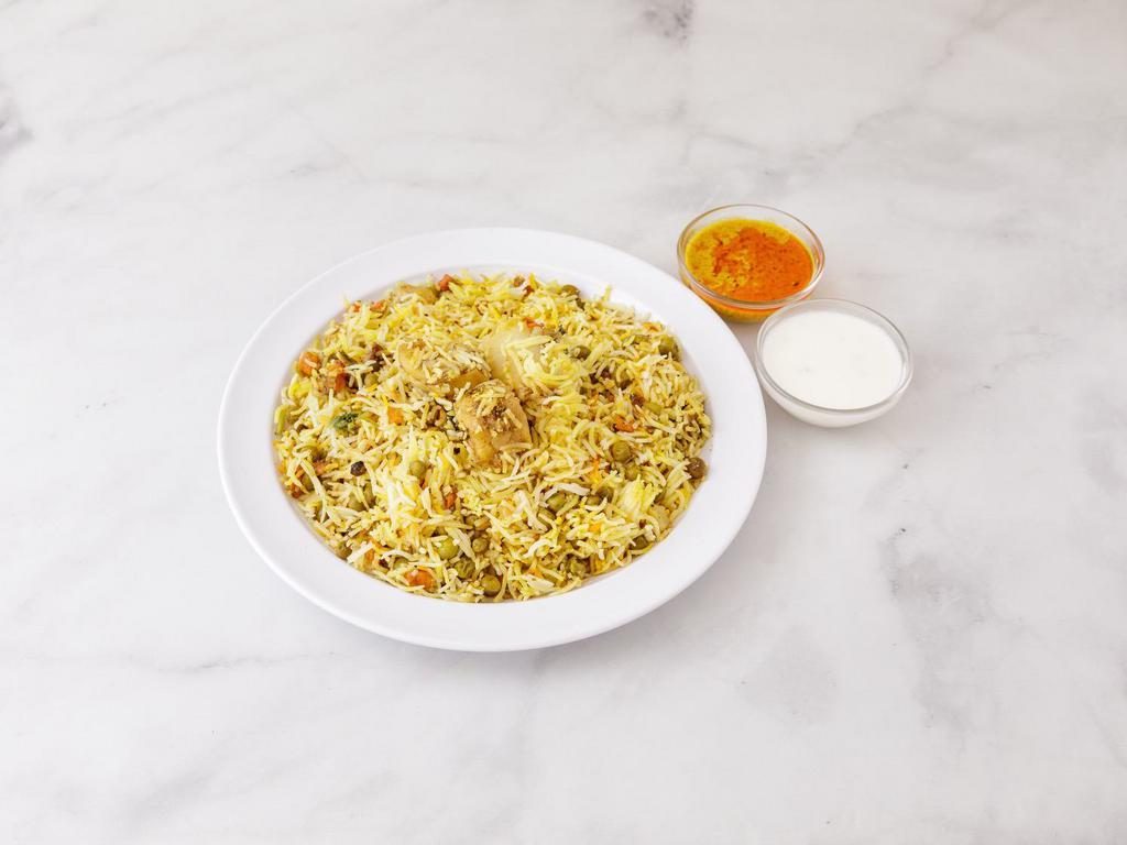 Vegetable Biryani · Basmati rice cooked with mixed vegetables a bland of herbs and saffron.