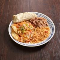 Huevos Rancheros · Fried eggs served upon lightly fried corn tortillas topped with tomato-chili sauce, served w...