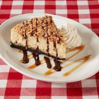Caramel Coconut Cheesecake · Caramel cheesecake on top of an Oreo cookie crust, topped with caramel glaze and
toasted coc...