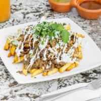 Asada Fries · French fries topped with refried beans, meat, salsa, cilantro, onions, cheese, and Mexican c...
