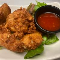 Chicken Wings  · Cooked wing of a chicken coated in sauce or seasoning.