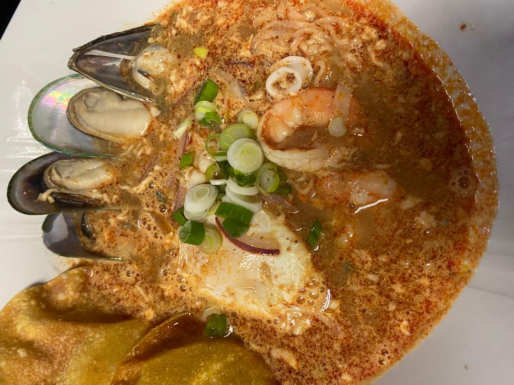 MaMa seafood tom yum soup · Steamed instant noodle, egg, red onions, lemon-grass with Tom Yum soup, sweet and sour.