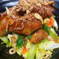 Duck Tamarind  · Crispy half duck in an aromatic tamarind sauce topped with fried shallots.