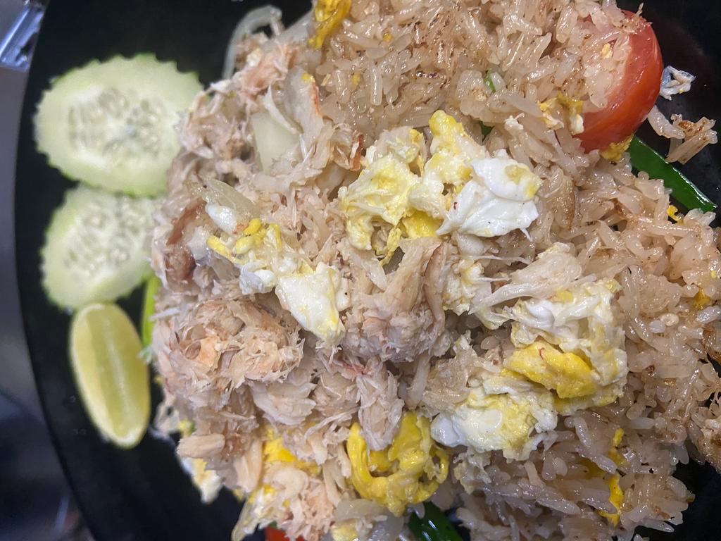 Crab Meat Fried Rice · Stir-fried jasmine rice with crab meat, onions, scallions, tomatoes and eggs.
