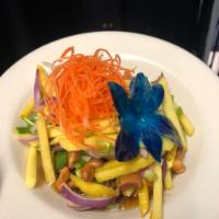 Mango Salad  · Spicy lime sauce, red onions, tomatoes and scallions.