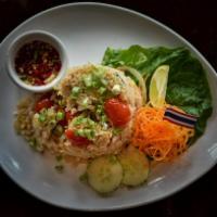 Classic Thai Fried Rice · Stir-fried jasmine rice with onions, scallions, tomatoes, mixed with peas and egg.