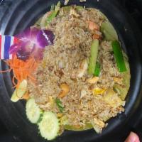 Pineapple Fried Rice · Stir-fried jasmine rice with curry powder, tomatoes, cashew nuts, onions, scallions, pineapp...