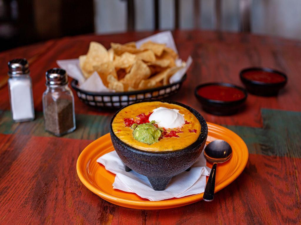 Aztec Dip · Ground beef, refried and black beans, tomatoes, guacamole, sour cream and chile con queso.