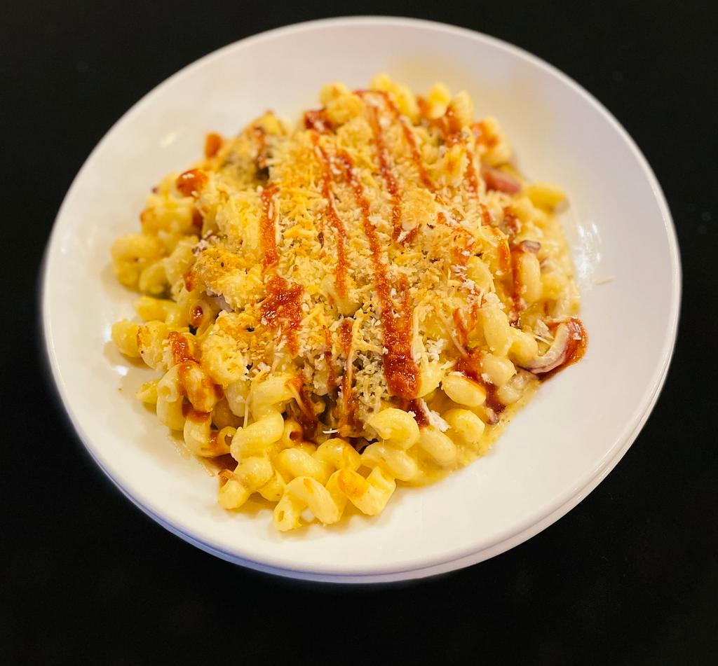 BBQ Mac and Cheese · pulled pork, smoked bacon, red onion, cavatappi pasta, cheddar, and muenster cheese sauce. topped with toasted bread crumbs.