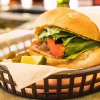 Milanesa Torta · Loaded with breaded steak, beans and veggies.