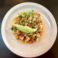 Ceviche Tostada · Prawns marinated in lime juice with pico de gallo and avocado sliced on top of a homemade co...