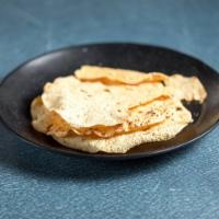 Papadum · Two pieces of mildly spices crisp lentil crackers roasted in a clay oven. 