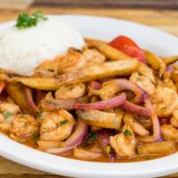 Saltado de Camarones · Stir fried shrimp, onions, tomatoes, fried potatoes, cilantro and soy sauce, served with gar...