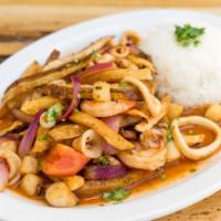 Saltado de Mariscos · Stir fried mixed seafood, onions, tomatoes, fried potatoes, cilantro and soy sauce, served w...