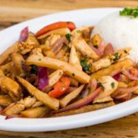 Saltado de Pollo · Stir fried chicken, onions, tomatoes, fried potatoes, cilantro and soy sauce, served with ga...