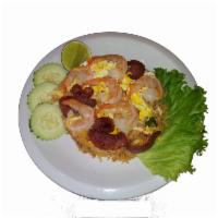 Thai Fried Rice · A spicy fried rice with pineapple, egg, white onion, green onion, and Chinese sausage with y...
