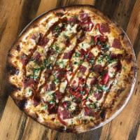 12'' Spicy Honey Italian Pizza · red chili sauce, mozzarella cheese, caramelized onions, roasted red peppers, salami, finishe...