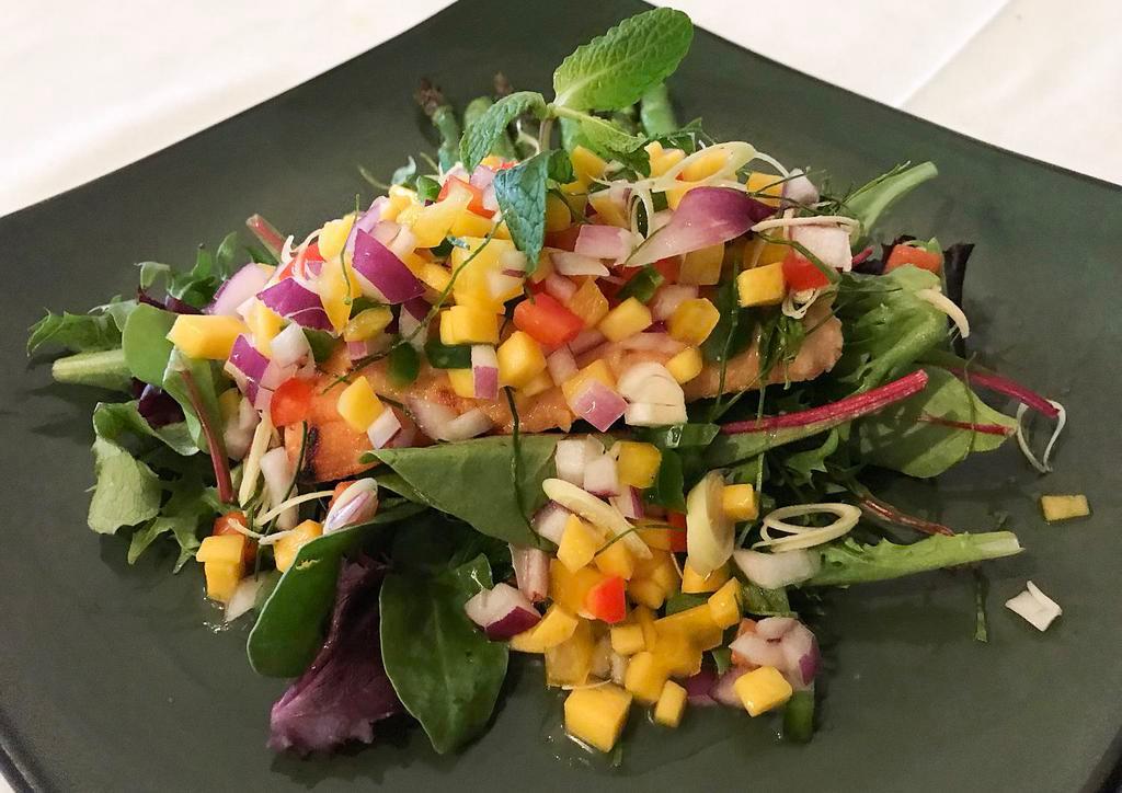 Healthy Salmon · Grilled salmon topped with fresh chopped mango salsa with red onion, kaffir lime leaves, lemongrass and chili.