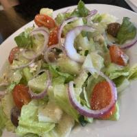 Greek Salad · Romaine, red onions, tomatoes, Kalamata olives, crumbled feta, cucumber, Greek dressing.