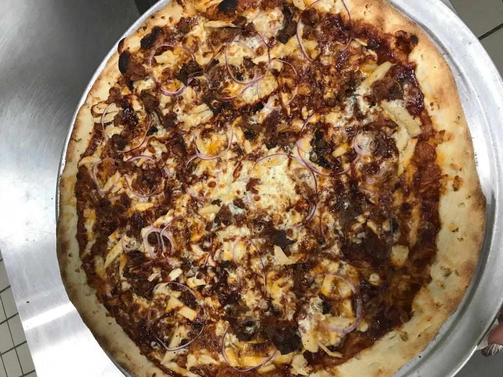 BBQ Chicken Pizza · B8Q sauce, chicken, red onions, bacon and cheddar.