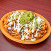Asada Fries · Carne asada fries topped with cheese, lettuce, guacamole, and sour cream.