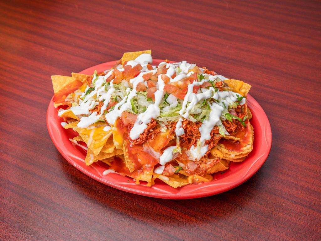 Nachos · Meat of your choice, beans, lettuce, pico de gallo, sour cream, and cheese.