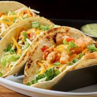 Free Range Chicken Tacos · Traditional Mexican Dish With A Brazilian Taste! Chicken with Cheddar Cheese, Lettuce, And V...