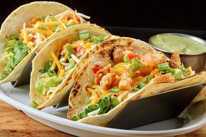 Free Range Chicken Tacos · Traditional Mexican Dish With A Brazilian Taste! Chicken with Cheddar Cheese, Lettuce, And Vinaigrette With Our Signature Quitutes Sauce.