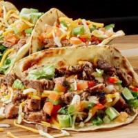 Brisket Tacos · Traditional Mexican Dish With A Brazilian Taste! Brisket with Cheddar Cheese, Lettuce, And V...