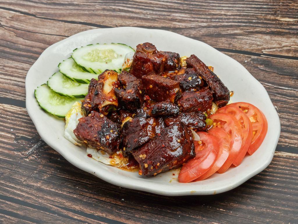 Spicy Ribs  · Short ribs topped with a sweet and spicy sauce.