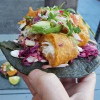 Fried Fish Tacos (2) · Fried Cod / blue corn tortilla / Guacamole / Citrus slaw / pico de gallo / Lime Crema / cila...